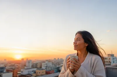 Young Woman on Rooftop at Sunrise