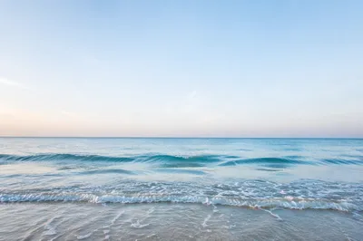 Calm Ocean Waves Under Morning Sky