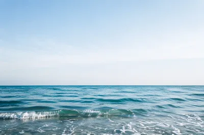 Calm Ocean Waves Under Pale Sky