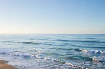 Calm Ocean Waves Under Morning Sky
