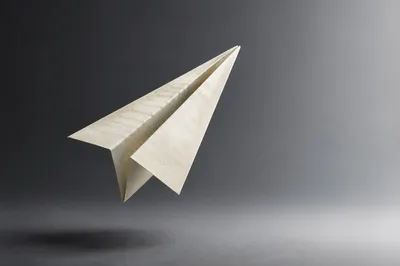 Ivory Paper Airplane on Gray Gradient