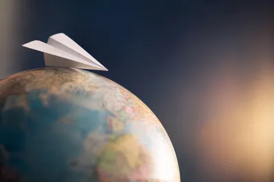 White Paper Airplane on Dreamy Gradient