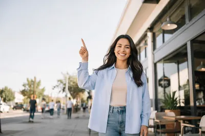 Smiling Woman Pointing Up on City Sidewalk