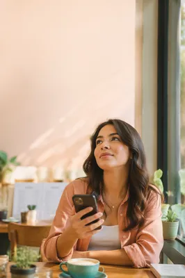 Young Woman Thinking at Cafe Window