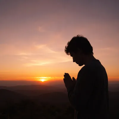Praying Hands Silhouette at Sunset Sky