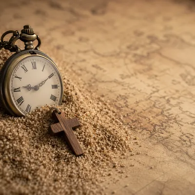 Pocket Watch on Sand and Vintage Map
