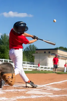 Youth Baseball Swing on Sunny Diamond