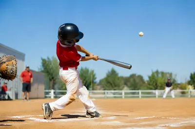 Youth Baseball Batter on Sunlit Diamond