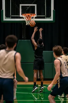 Basketball Dunk Through Indoor Gym Hoop
