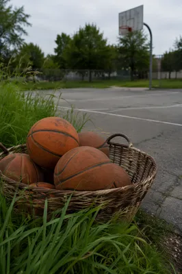 Worn Basketballs by Neighborhood Court Hoop