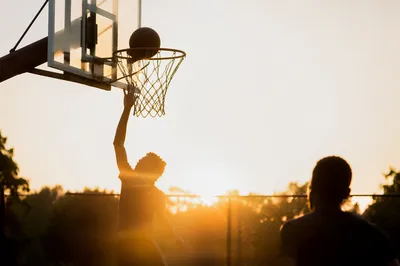 Golden Hour Basketball Layup on Outdoor Court