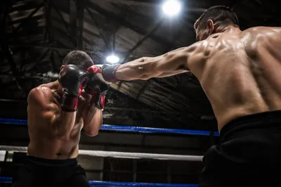 Intense Boxing Sparring Under Arena Lights
