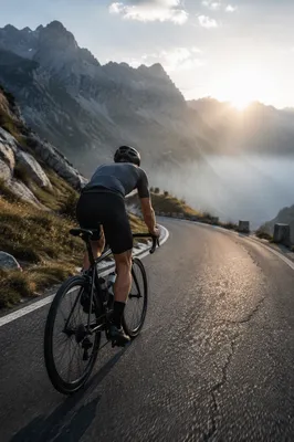 Road Cyclist Climbing Misty Mountain Pass