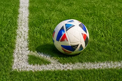 Soccer Ball on Green Corner Field