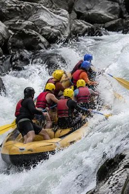 Yellow Raft Charging Through White Water Rapids