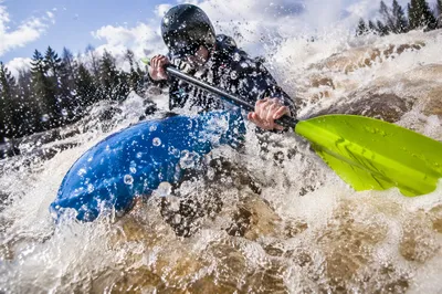 Whitewater Kayaker Charging Through River Rapids