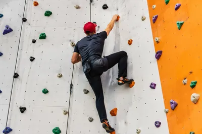 Indoor Rock Climber on Modern Gym Wall