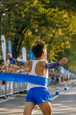 Marathon Runner Breaking Blue Finish Ribbon