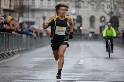 Marathon Runner Sprinting Toward Urban Finish