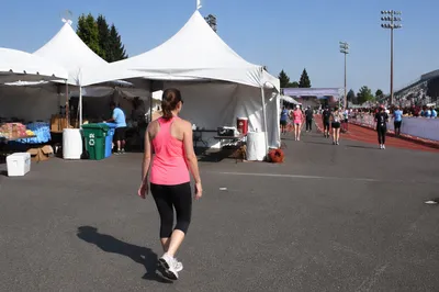 Female Runner Near Marathon Finish Tents