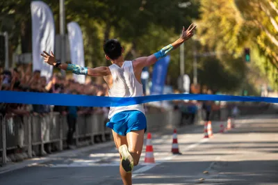 Marathon Runner Breaking Blue Finish Ribbon