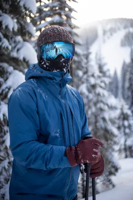 Skier Paused on Snowy Mountain Trail