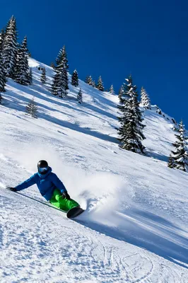 Downhill Skier Carving Powdery Alpine Slope