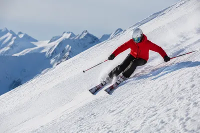 Skier Carving Down Steep Snowy Slope