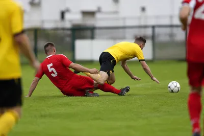 Amateur Soccer Sliding Tackle on Green Field