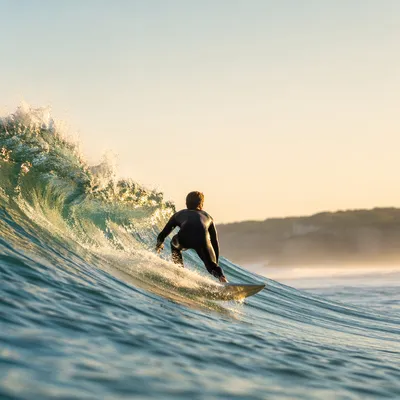 Lone Surfer on Turquoise Morning Wave
