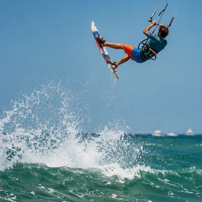 Kitesurfer Soaring Above Summer Ocean Wave