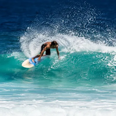 Surfer Carving Through Turquoise Summer Wave
