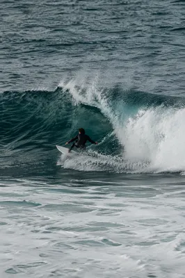 Surfer Carving Through Turquoise Summer Wave