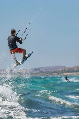 Kitesurfer Jumping Over Turquoise Summer Waves
