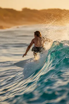 Surfer Riding Turquoise Wave at Golden Hour