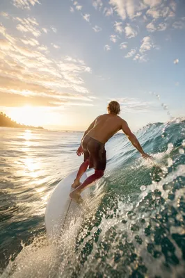 Surfer Riding Turquoise Wave at Sunrise