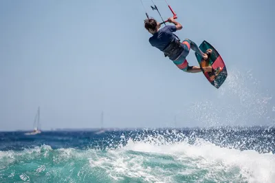 Kitesurfer Soaring Above Summer Ocean Wave