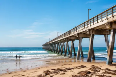 Distant Surfers by Quiet Summer Pier