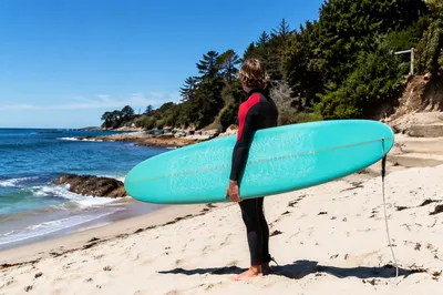 Summer Surfer Holding Turquoise Board by Ocean