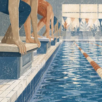 Swimmers Poised at Indoor Pool Starting Blocks