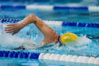 Competitive Swimmer Racing Through Indoor Pool Lane