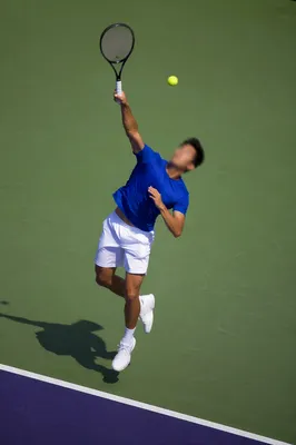 Tennis Player Mid-Serve on Hard Court