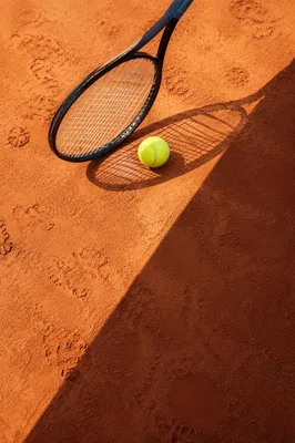 Tennis Racket and Ball on Clay Court