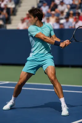 Tennis Player Mid Swing on Outdoor Court