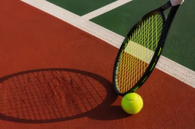 Tennis Racket and Ball on Court