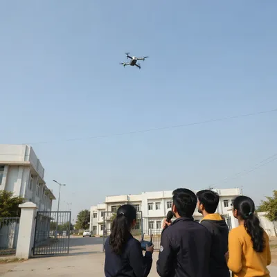 Autonomous Drone Over Modern Campus Entrance