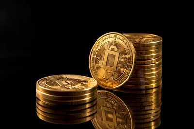 Golden Cryptocurrency Coins on Black Reflection