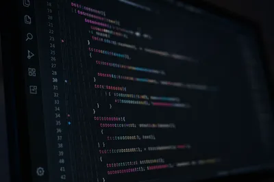 Dark Programming Code on Glowing Monitor