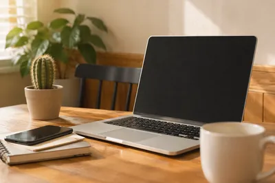 Modern Laptop Workspace with Plants and Warm Wood