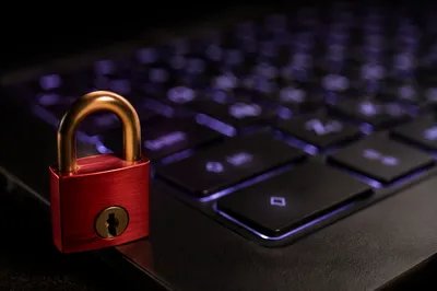 Red Padlock on Glowing Laptop Keyboard